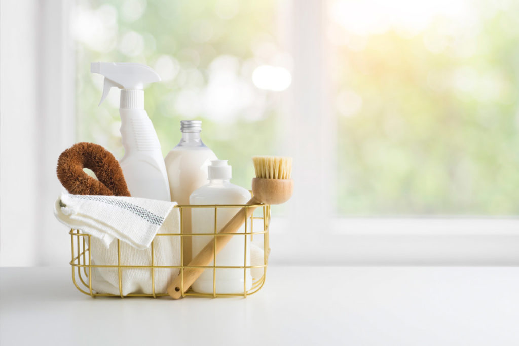 eco friendly cleaning products in a basket in front of a window | shark vacuum spring cleaning checklist